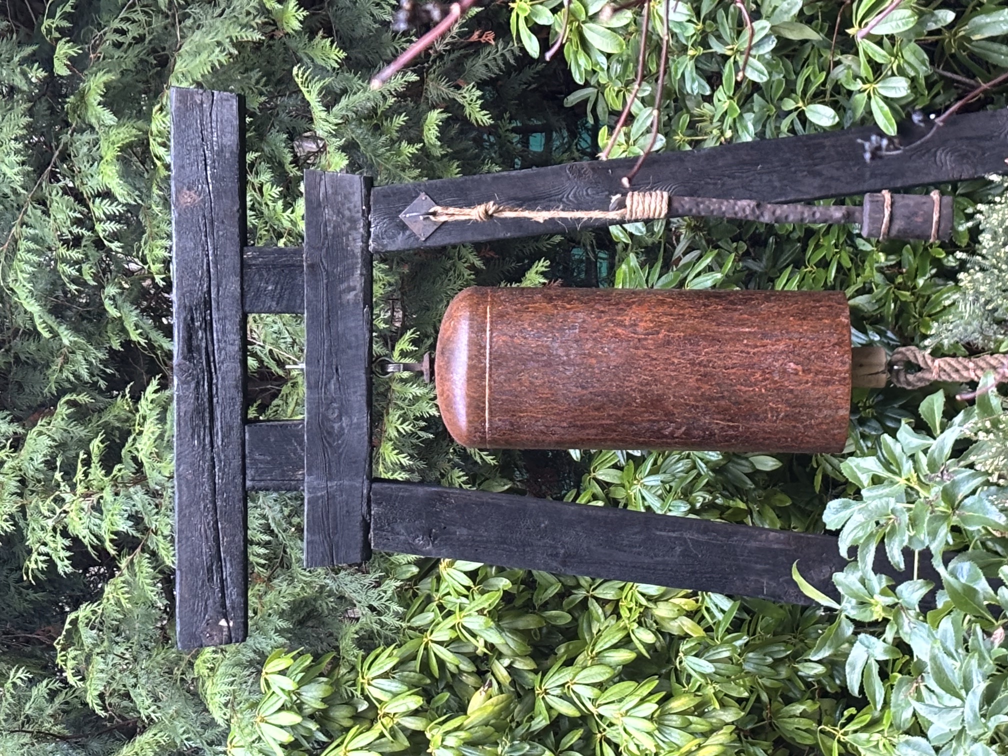 Hand-forged steel bell on timber gate